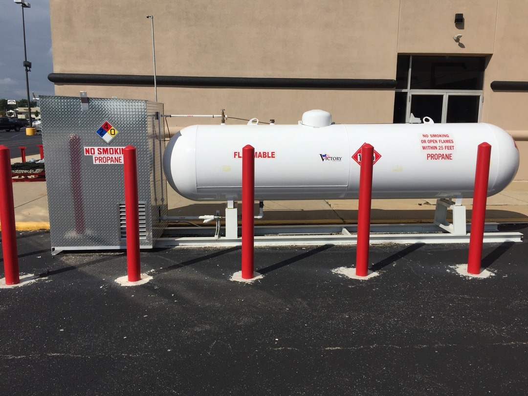 propane tank and steel cabinet behind red bollards with