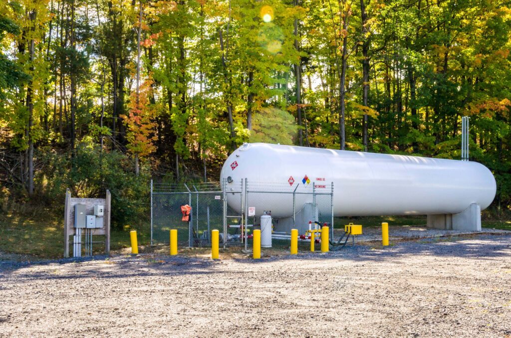 propane tank in front of the forest