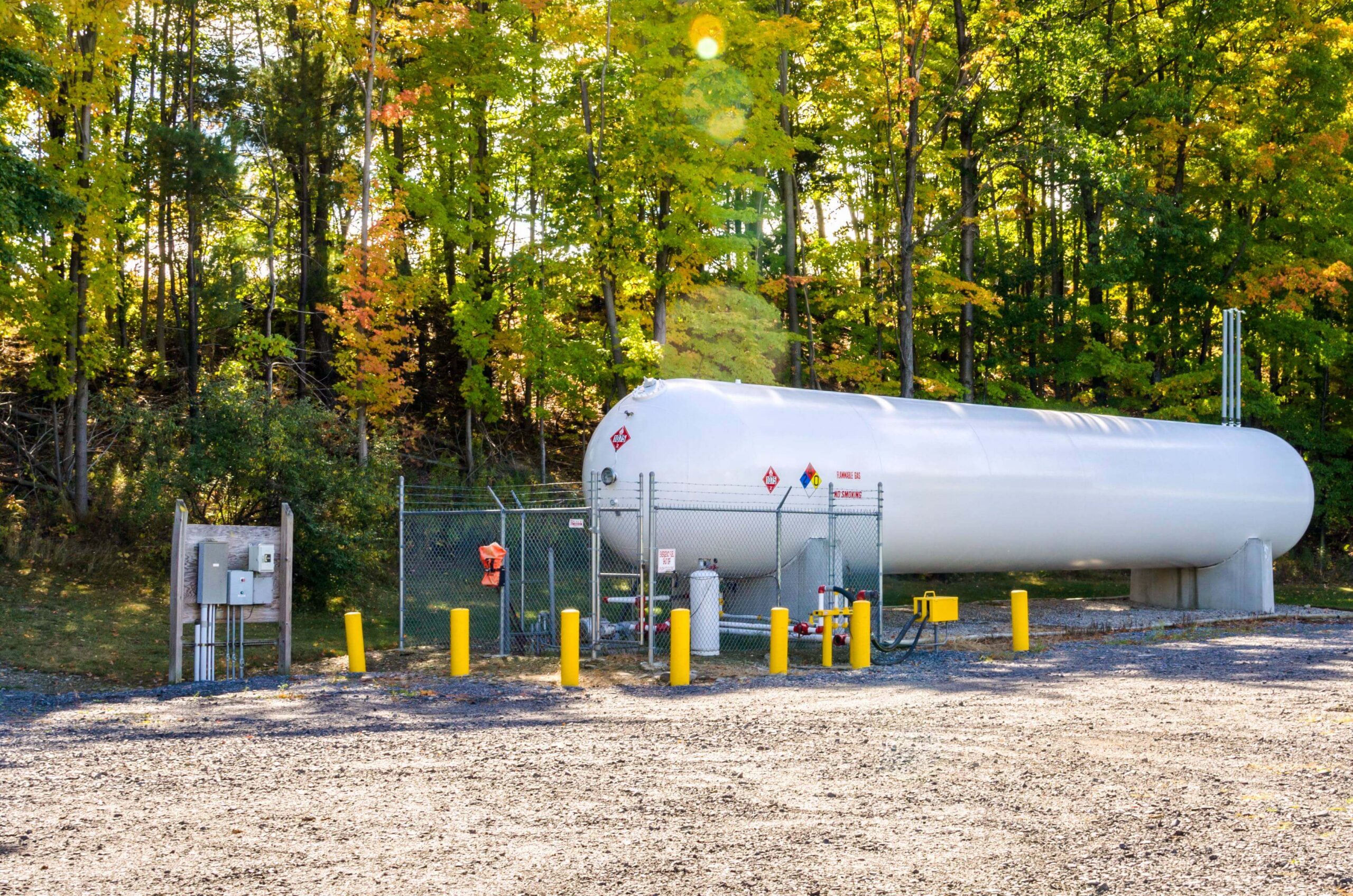 propane tank in front of the forest