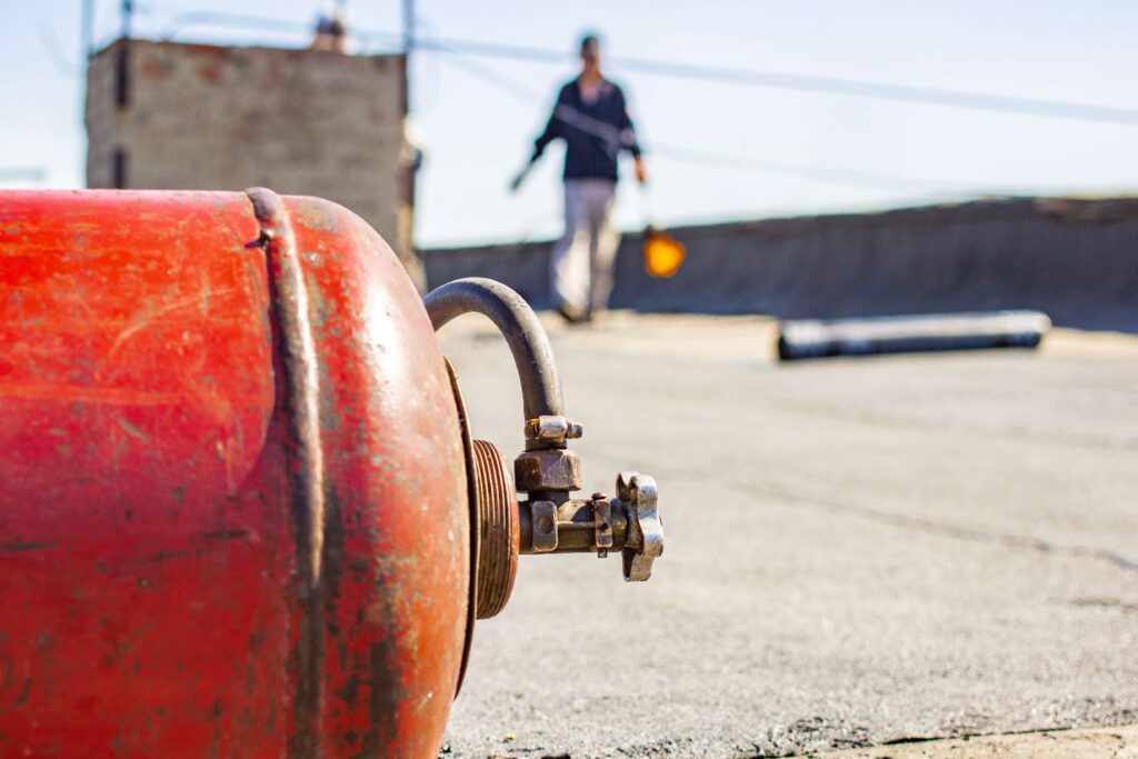 propane tank nozzle with person walking up