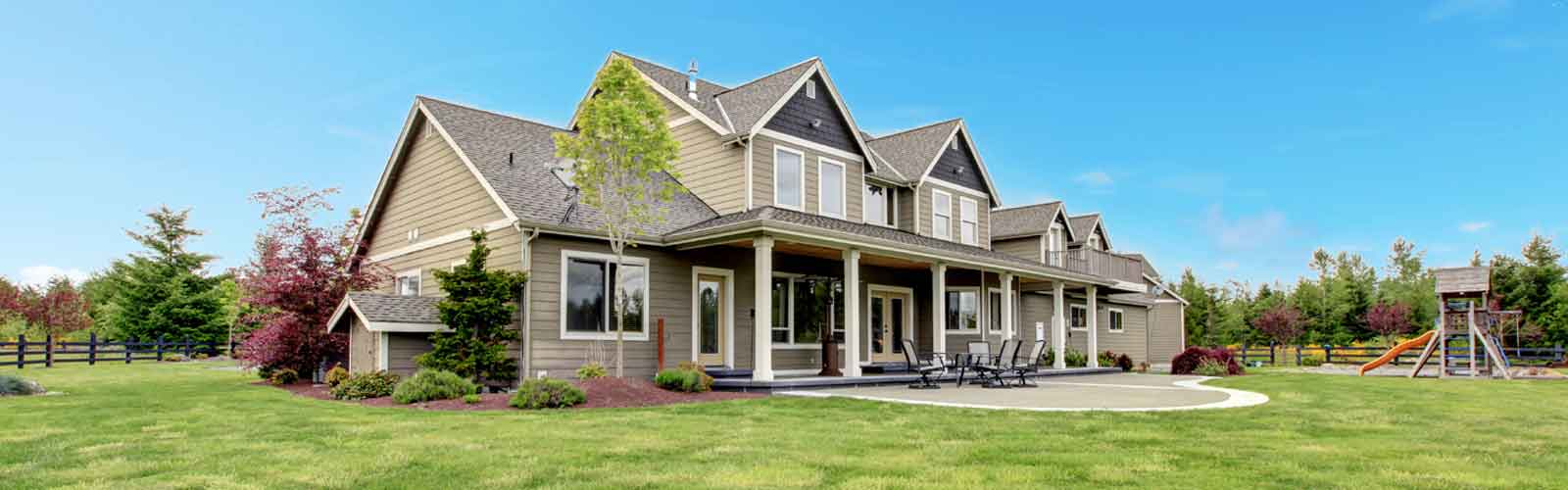 large family home views from the front-side lawn with swingset in the distance